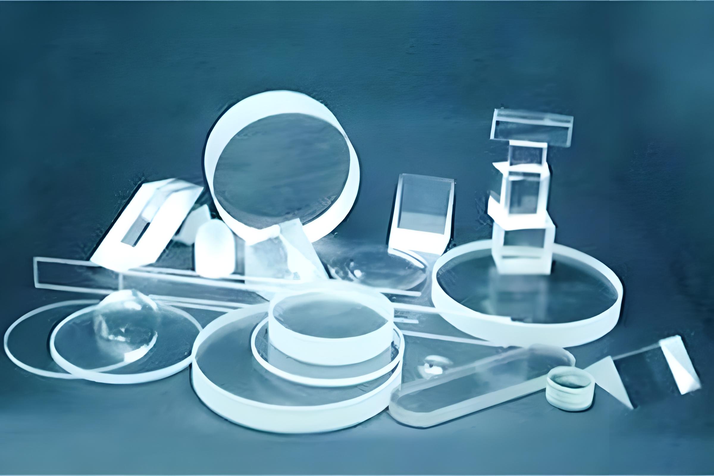 CaF2 (Calcium Fluoride) optical crystal components in various shapes, including lenses, prisms, and windows