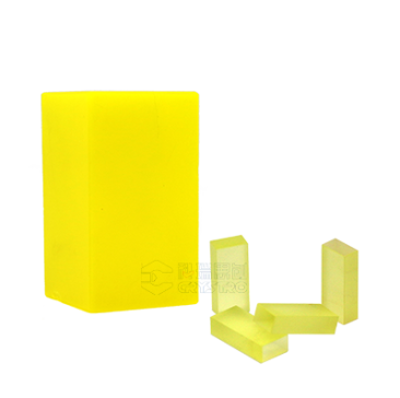 Ce:GAGG scintillator crystal, yellow-tinted cuboid boule and cut pieces
